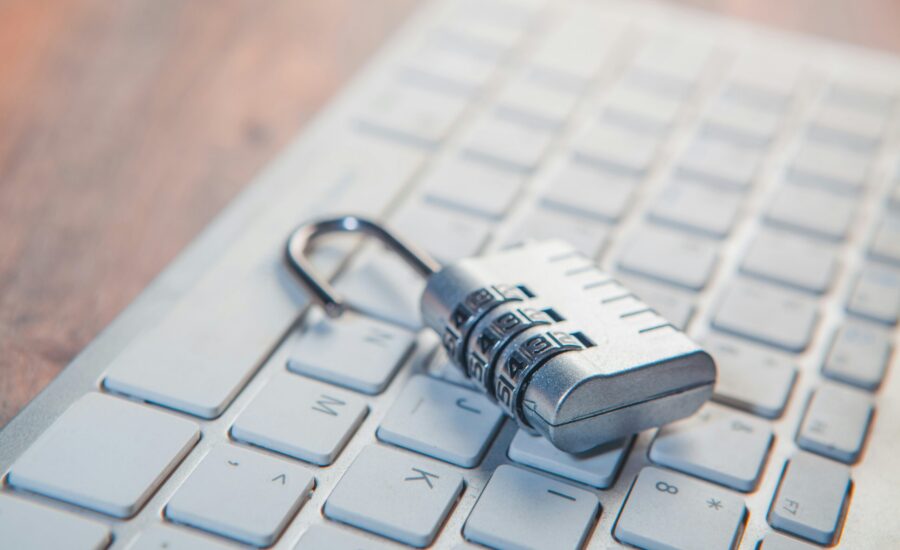 A combination lock rests on a computer keyboard.